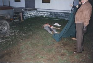 Photograph of Ray Hensen, deceased. It is alleged that he assaulted Mr. Waller with the pipe visible above the body. Mr. Waller fired in self-defense.