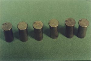 Photograph of the 6 cartridge cases recovered from Mr. Waller’s revolver. Note the double firing pin strike on the left most case.