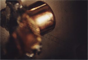 This photograph is of a recovered bullet in this case. Note that the expansion deformation makes mounting of the sample in a microscope extremely problematic. Also, the deformation negates the possibility of using a high enough magnification (with its extremely short focal length, requiring the lens to be closed than four hundredths of an inch) to detect individual striations on the bullet of less than .001 inches, smaller than one/fifth the thickness of the paper on which this is printed.